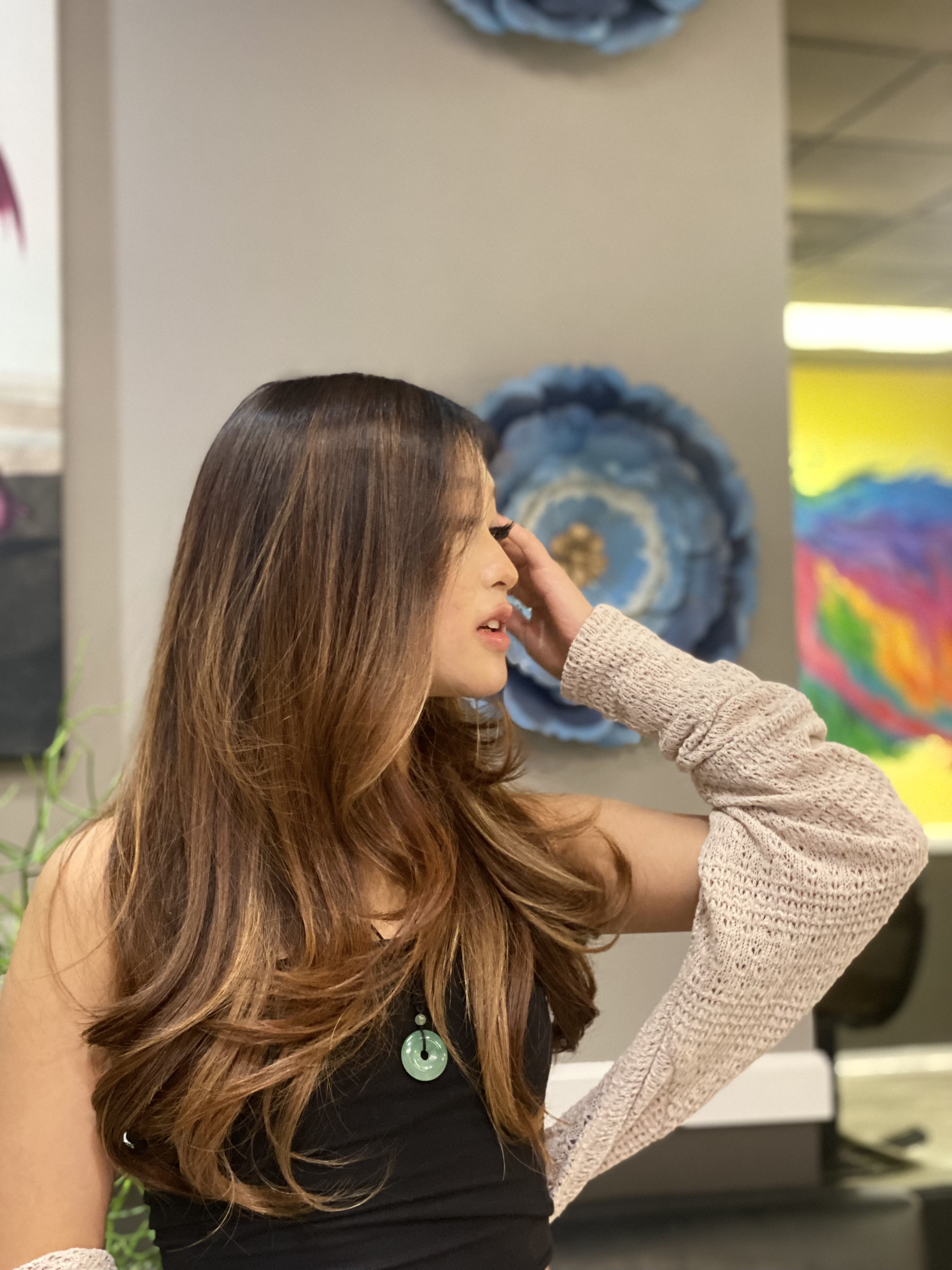 Women's long layered haircut with soft balayage styling